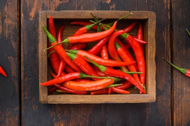 Sıcak kırmızı thai biber seti, ahşap kutuda, eski siyah ahşap masa, üst düz yatıyordu