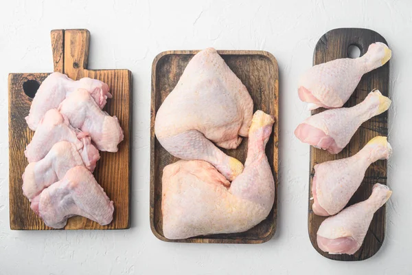 Fresh chicken meat cuts Farm poultry meat set, on wooden cutting board, on white background, top view flat lay