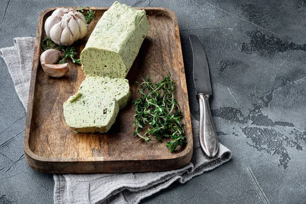 Portion of Herb Butter with Chives, Basil, Oregano, Parsley set, on gray stone background, with copy space for text