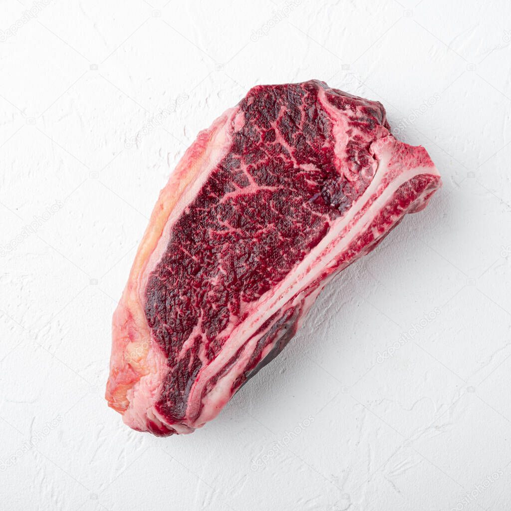 raw steak prepared for cooking set, square format, on white stone  surface