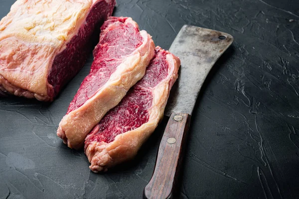 Top sirloin beef steaks cut, on black background, with copy space for text