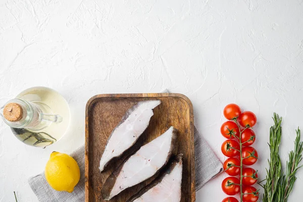 stock image Piece of fresh raw halibut fish set, with ingredients and rosemary herbs, on white stone table background, top view flat lay, with copy space for text