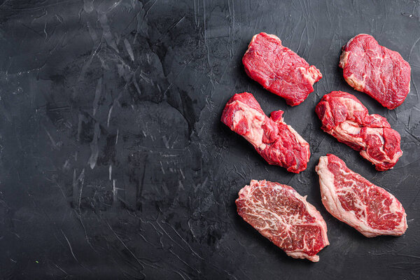 Raw beef steak cuts with top blade, chuck roll and rump steak, top view, space for text