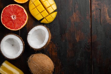Tropikal meyveler, ananas, mango ve portakal seti, eski koyu ahşap masa arkaplanı üzerinde, üst görünüm düz, metin alanı için kopya alanı ile