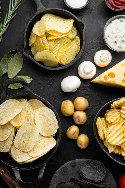 Variation different potato chips set, on black stone background, top view flat lay