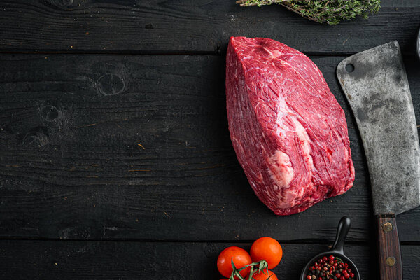 Beef cut  raw set with old butcher cleaver knife, on black wooden table background, top view flat lay,  with copy space for text