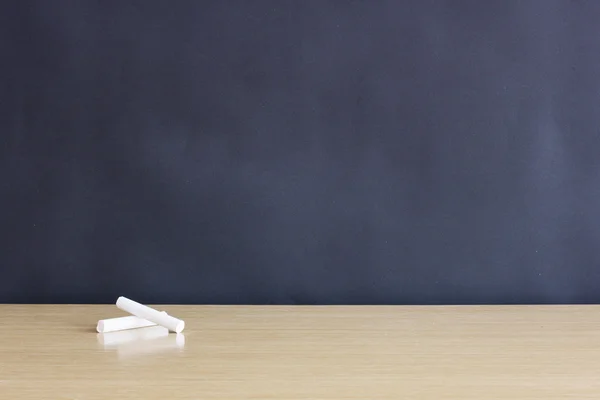 Chalks on wooden desk — Stock Photo, Image