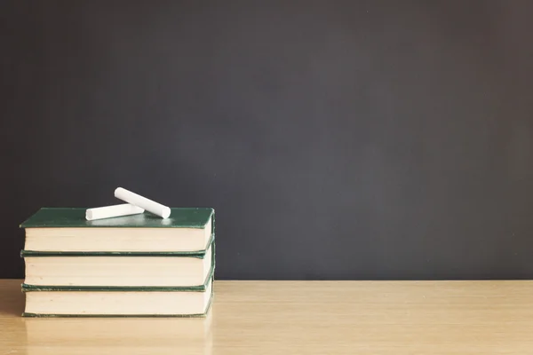 Books and chalks on table — Stock Photo, Image