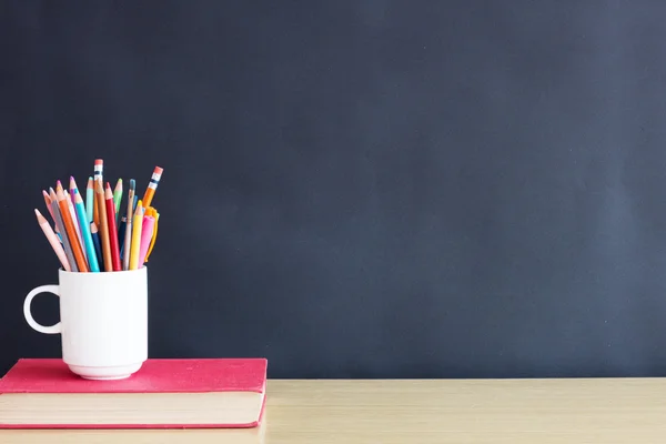 Pencils and book on table — Stock Photo, Image