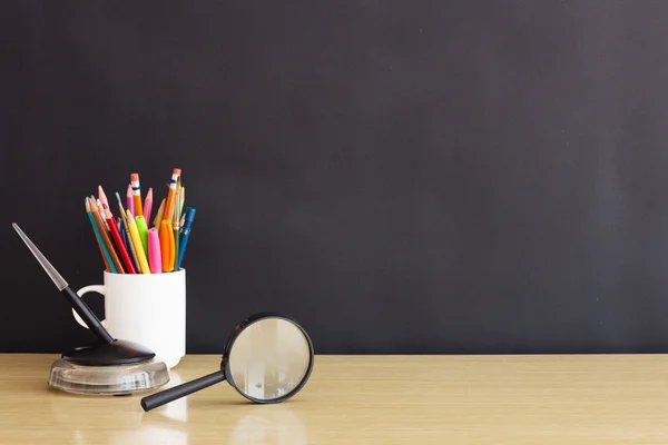 Pencils, pen, magnifying glass — Stock Photo, Image