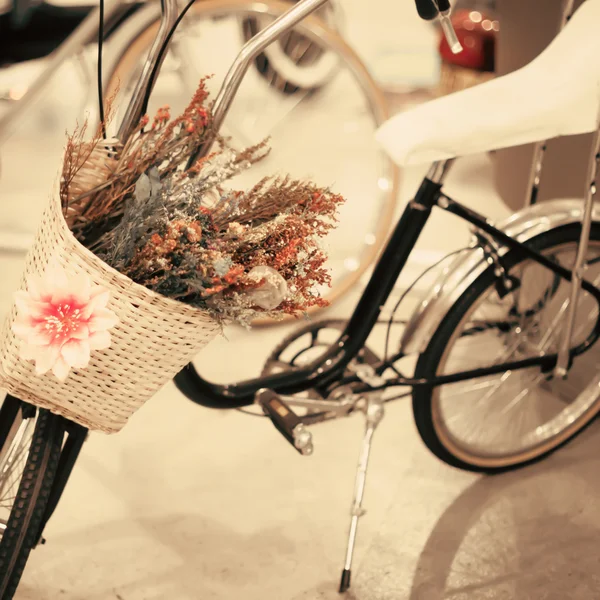 Bicycle with flowers in basket — Stock Photo, Image