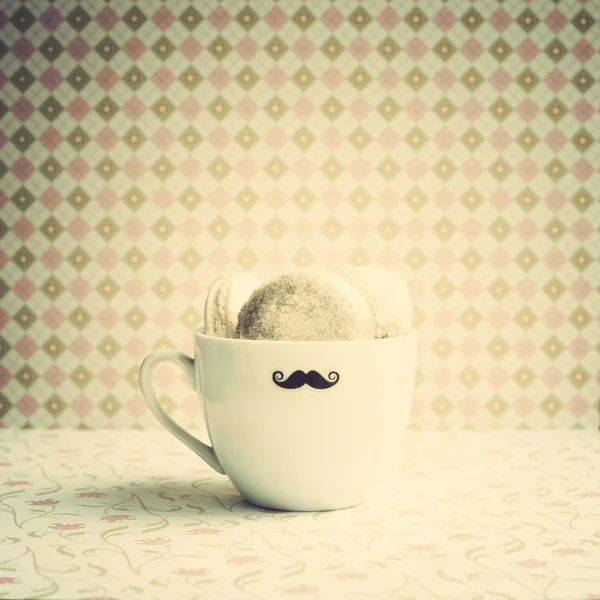 Macaroons in mustache cup — Stock Photo, Image