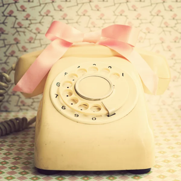 Telephone with pink bow — Stock Photo, Image