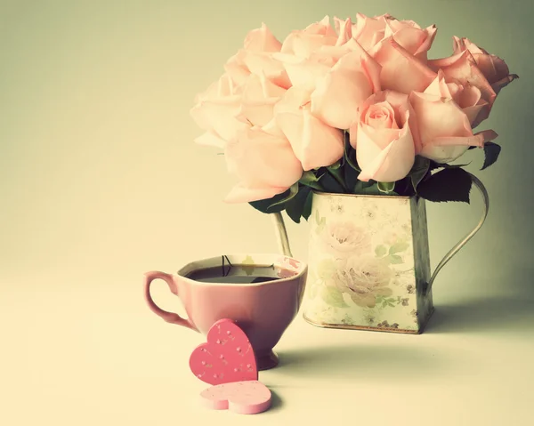玫瑰在花瓶和杯咖啡的心 — 图库照片