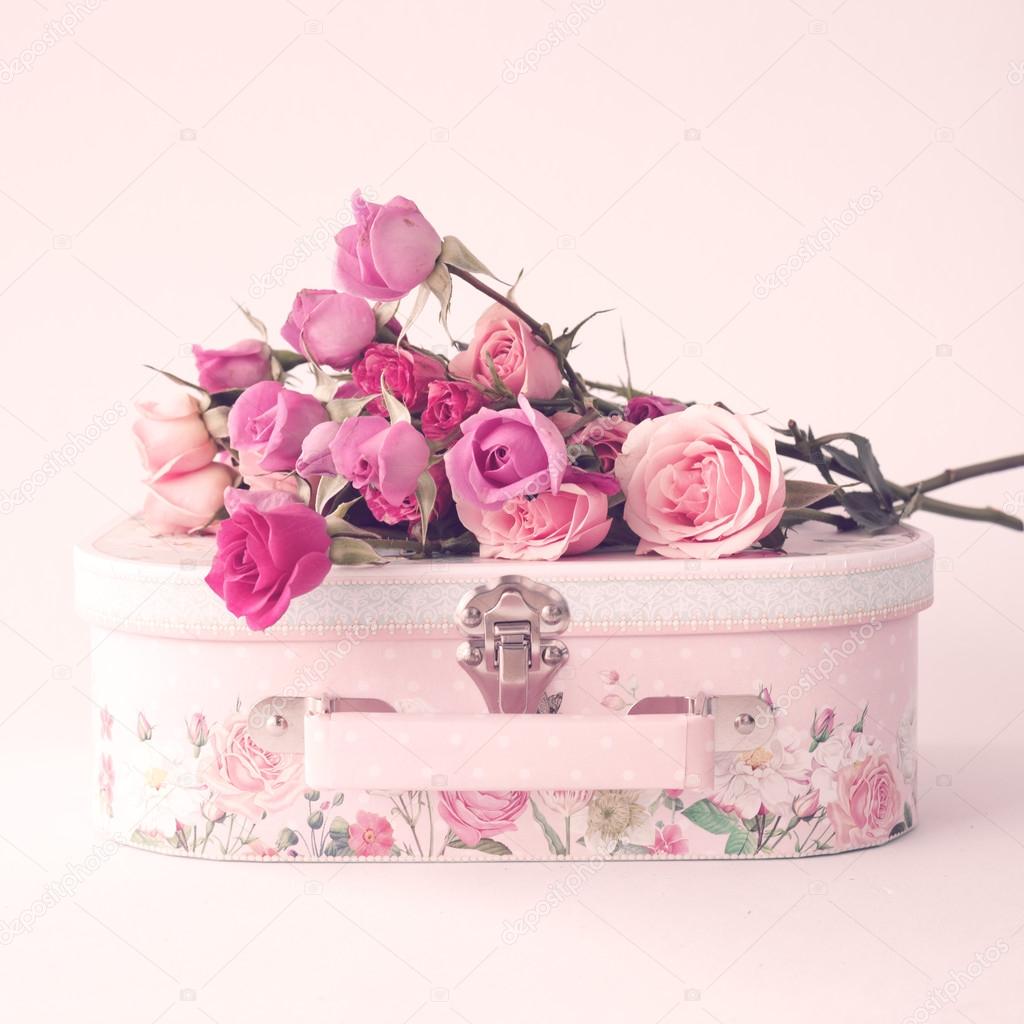 Pink roses on retro suitcase