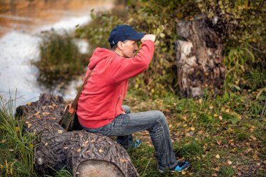 A creamy cake with clices if oranges on blue plate on white background, isolated.