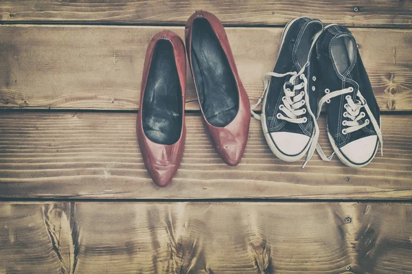 Different shoes on a wooden table — Stock Photo, Image