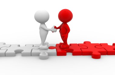 Puzzle parçaları üzerinde işadamları el sıkışma