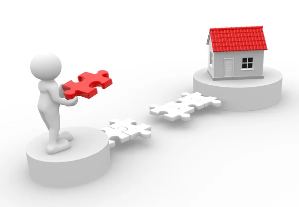 Man with piece of puzzle and a house — Stock Photo, Image