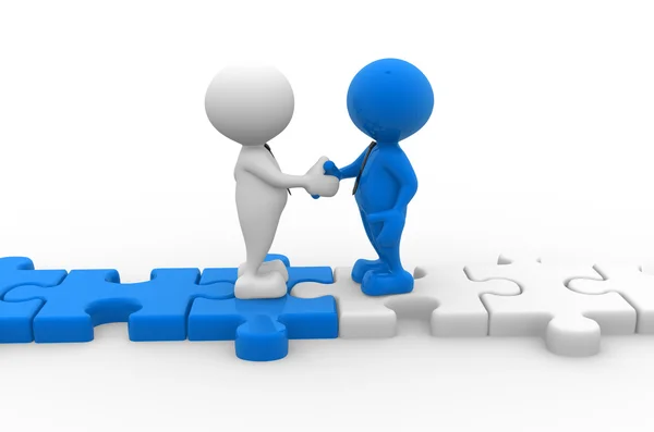 Erkekler tokalaşırken puzzle parçaları üzerinde