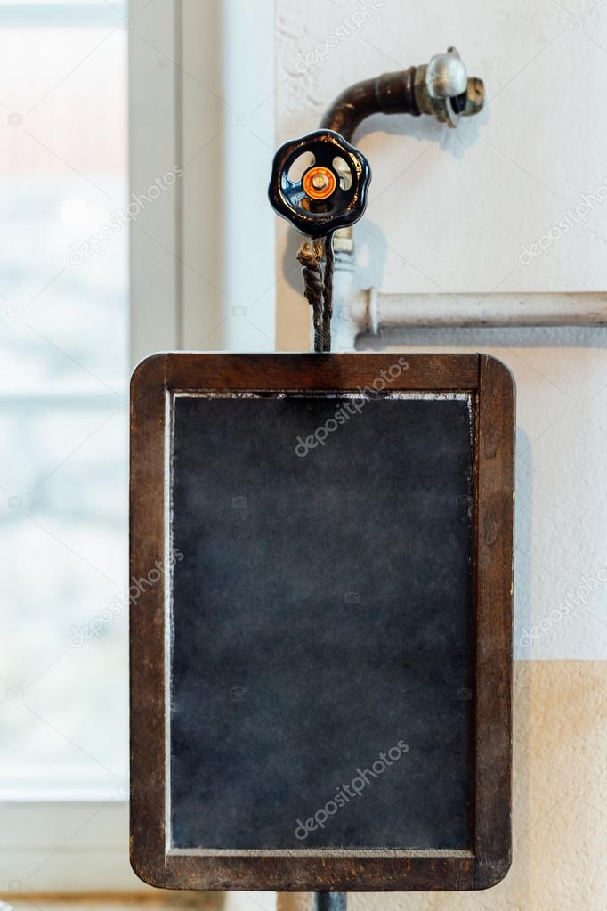 Vintage slate chalk board hanging on wooden background