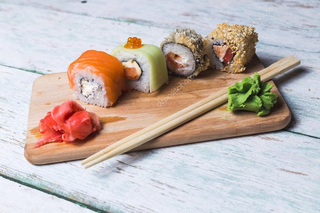 Sushi rolls on a wooden board