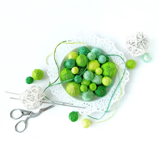 White basket with green knitting yarn and crochet hooks. — Stock Photo, Image