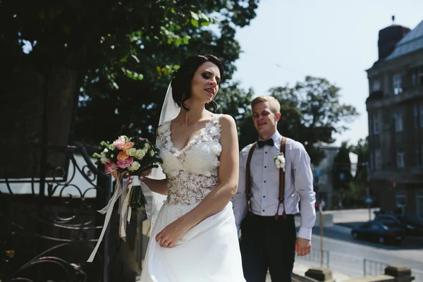 Невеста и жених позируют на улицах — стоковое фото