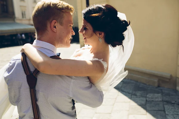 Marié porte mariée dans ses bras — Photo