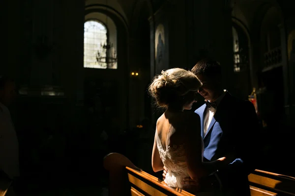 Bride and groom illuminated by light — Stock Photo, Image