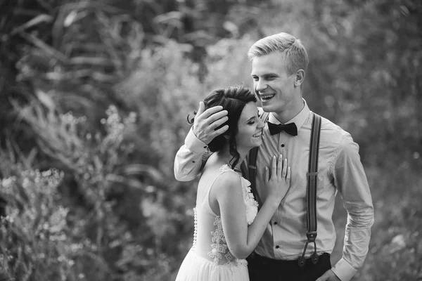 Groom gently embracing bride — Stock Photo, Image