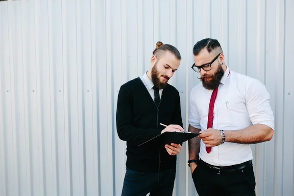 Two bearded businessman signing documents — Stock Photo, Image