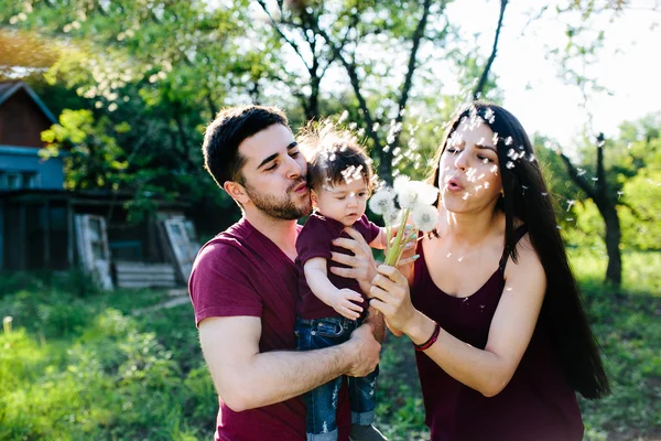 Young family with a child on the nature — Stock Photo, Image