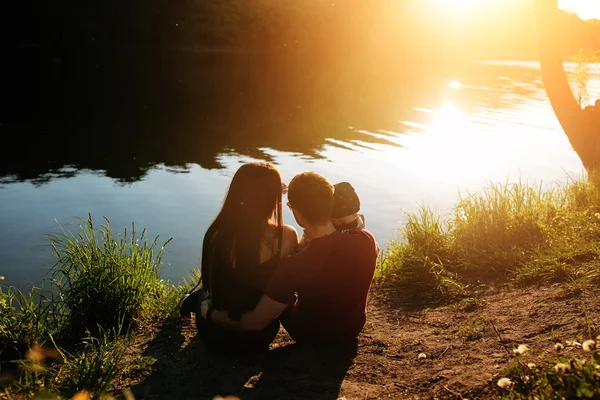 Young family with a child on the nature — Stock Photo, Image