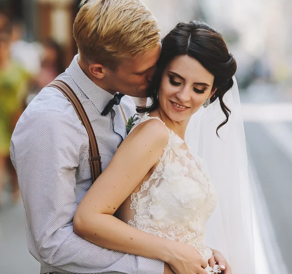 Groom hugs bride — Stock Photo, Image