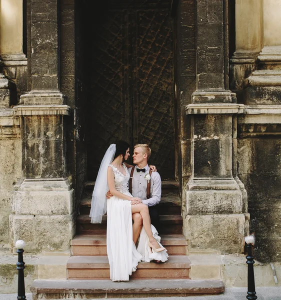 Bride sitting on lap of the groom — Stock Photo, Image