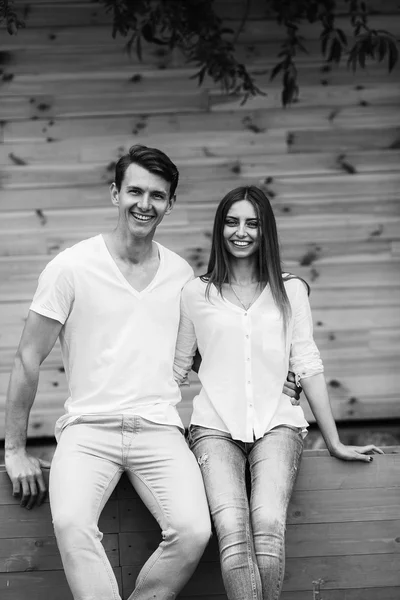 Couple posing on a background of the wooden wall Royalty Free Stock Photos