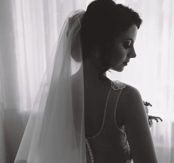 Bride posing in a large window — Stock Photo, Image