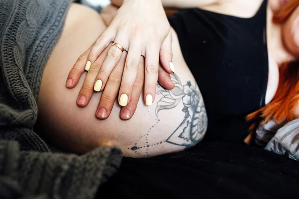 Pregnant woman and man lying on a bed — Stock Photo, Image