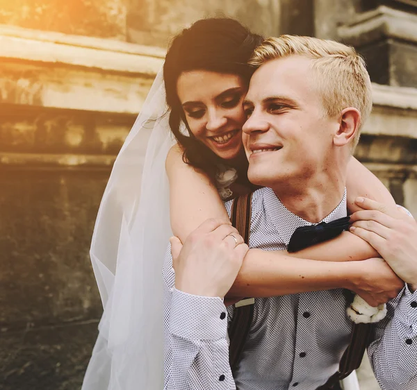 Bräutigam trägt Braut auf dem Rücken — Stockfoto