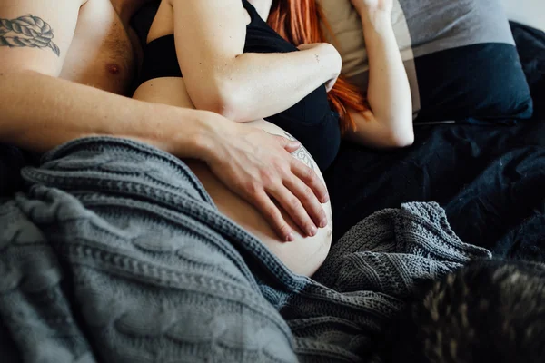 Hamile kadın ve erkek bir yatakta yatarken — Stok fotoğraf