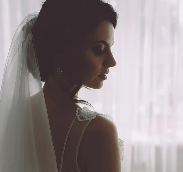 Bride posing in a large window — Stock Photo, Image