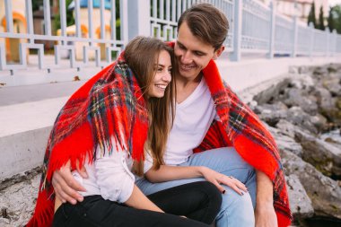 Sahilde oturan genç güzel Çift