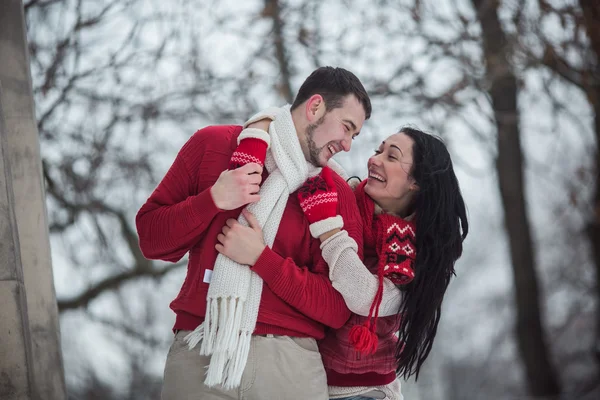 Чоловік і жінка обіймаються в засніженому парку — стокове фото