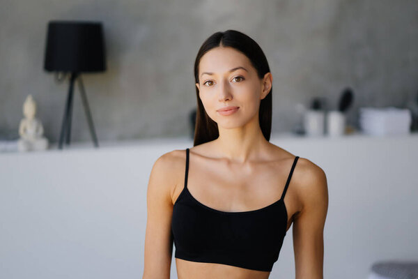 Beautiful young girl posing in lingerie in the living room