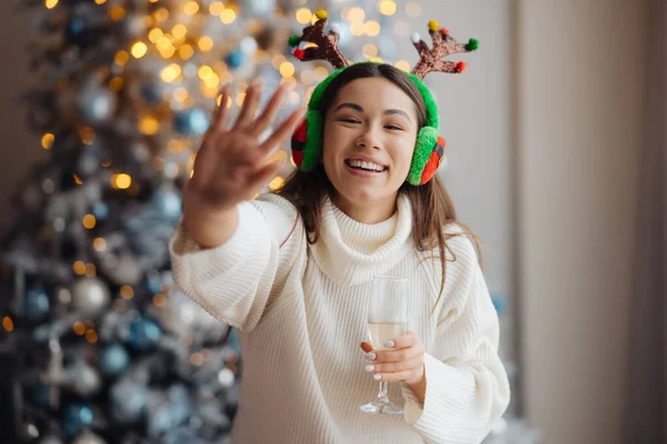 Krásná mladá žena se sklenkou šampaňského doma. — Stock fotografie