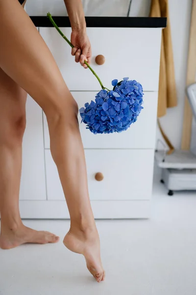 Fénykép gyönyörű női lábak kék virágok, közelkép. — Stock Fotó