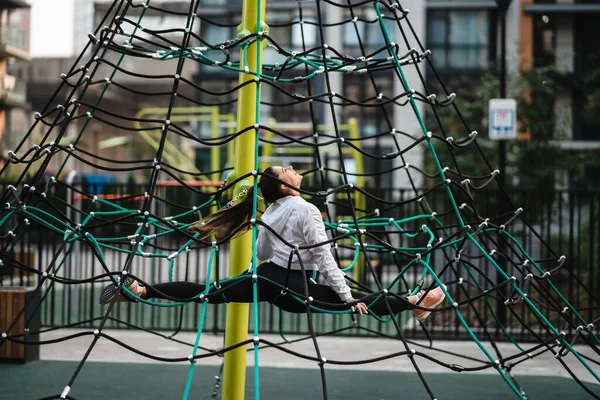 Jeune femme s'amuser sur la pyramide de corde — Photo