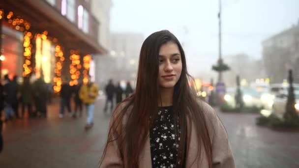 Jeune belle fille dans un manteau gris marchant dans la rue — Video