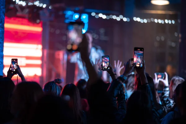 Person close up of recording video with smartphone during a concert. — Stock Photo, Image